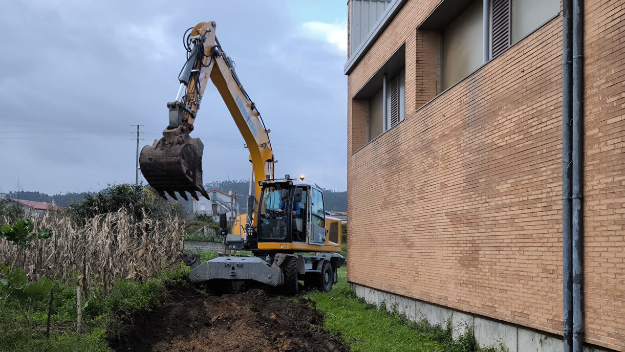 La reforma del pabellón de Vilalonga arrancó en la mañana de este martes con las excavaciones de tierra en el perímetro exterior de las instalaciones. DS